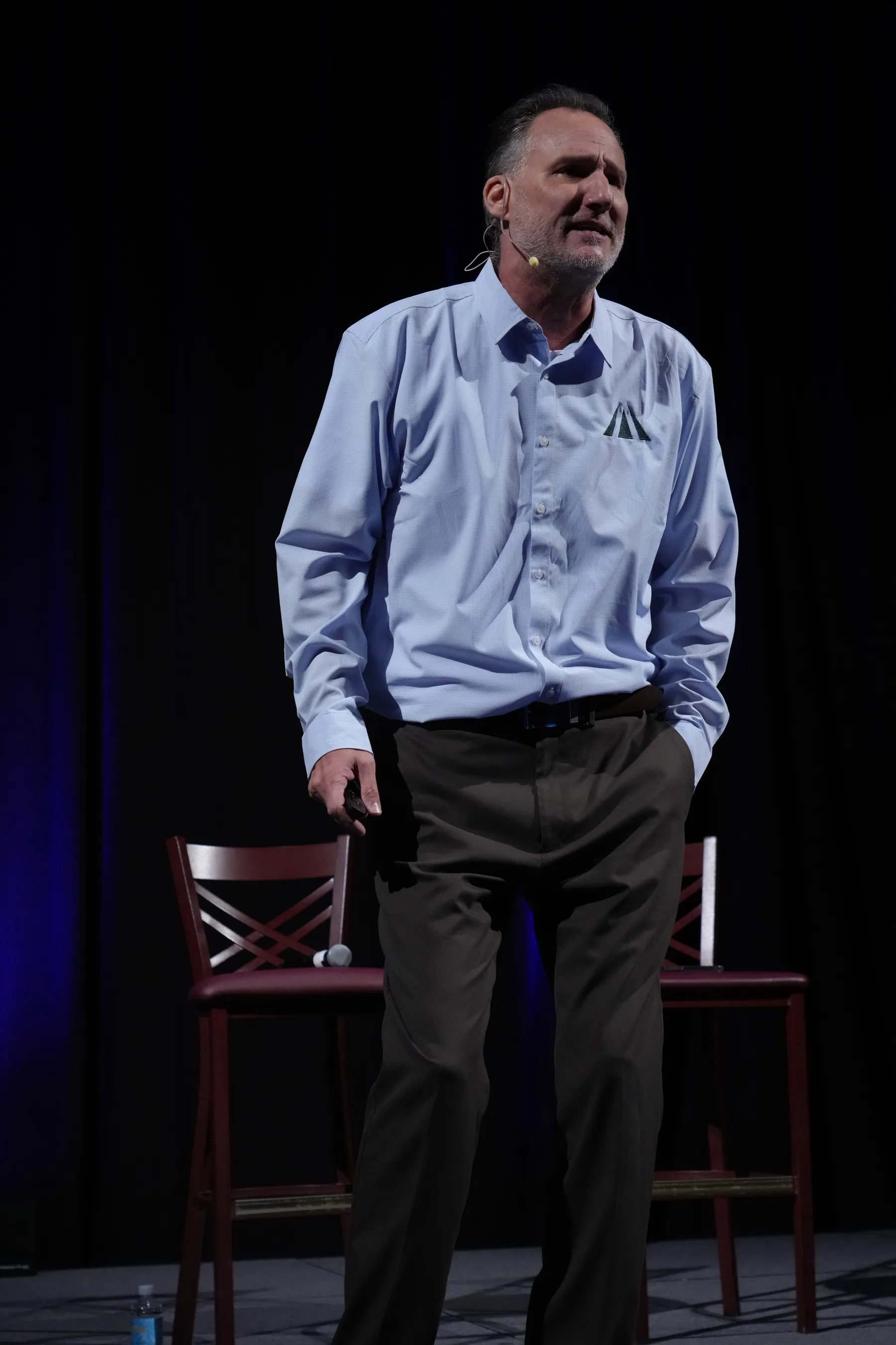 Mike Millett on a darkened conference stage during a keynote